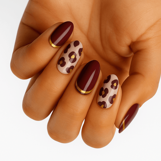 Hand displaying burgundy and nude leopard print non-UV nail wraps in autumn colours