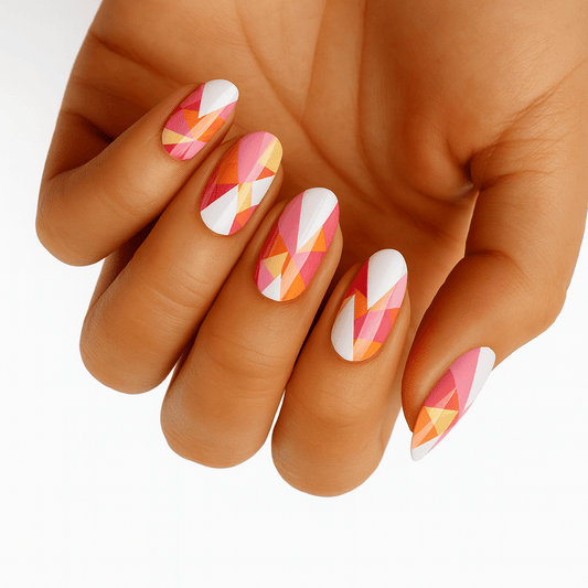 Hand wearing geometric nail wraps with pink coral orange abstract pattern for at-home manicure