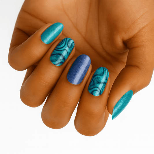 Hand displaying blue teal marble nail wraps with metallic ocean pattern