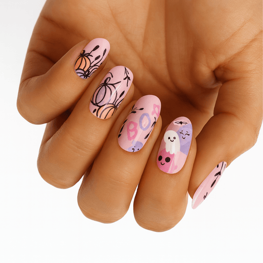 Pink Halloween nail wraps with cute kawaii pumpkins and ghosts on hand