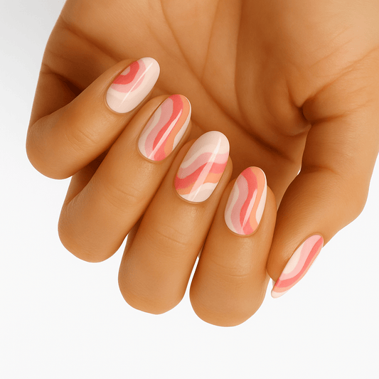 Pink marble swirl nail wraps on hand showing abstract cream and coral pattern