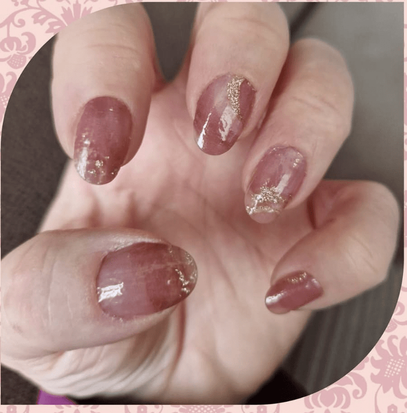 Rose quartz nail wraps with champagne foil accents on natural nails manicure