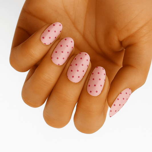 Pink polka dot nail wraps applied on hand showing classic retro pattern