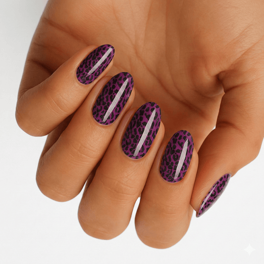 Purple leopard print nail wraps on hand showing metallic animal print manicure design