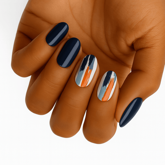 Navy and orange geometric nail wraps with modern stripe patterns on hand