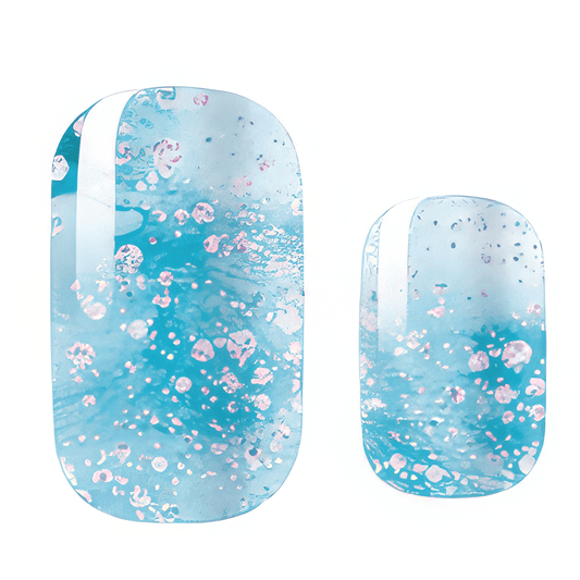 Blue glitter nail wraps with white pearl shimmer effects for winter manicure designs