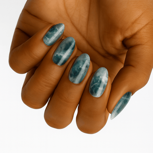 Teal marble nail wraps on hand showing sea glass effect nail art design