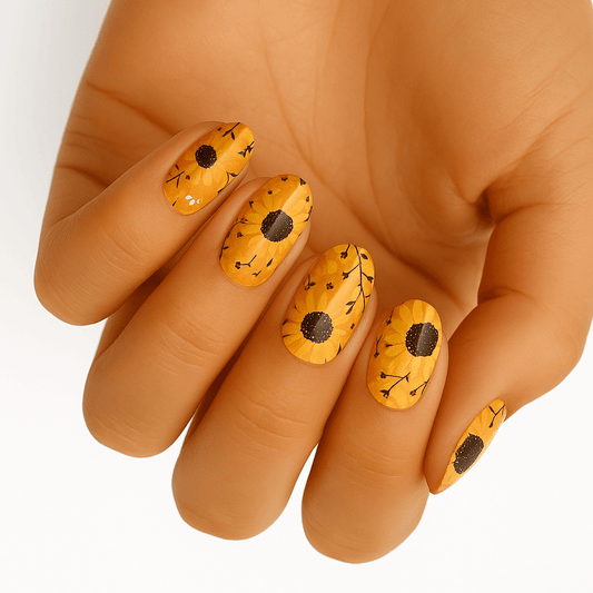 Yellow sunflower nail wraps applied on hand showing botanical floral design