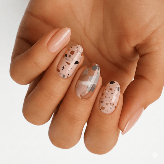 Terrazzo nail wraps on hand showing speckled stone pattern neutral nail art