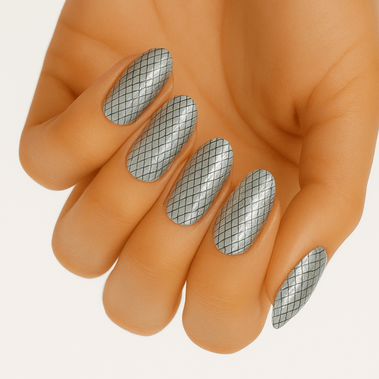 Holographic silver grid pattern nail wraps on hand showing geometric diamond design