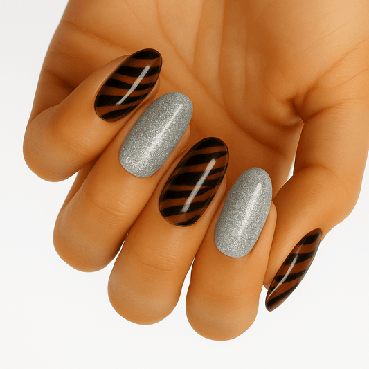 Tiger stripe nail wraps on hand with silver glitter accent nails at-home manicure