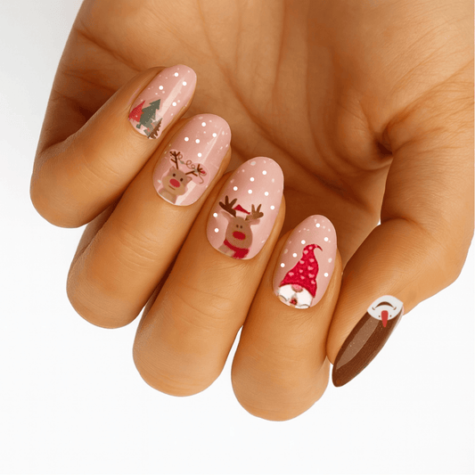 Christmas nail wraps featuring Santa, reindeer and holiday characters on pink base nails