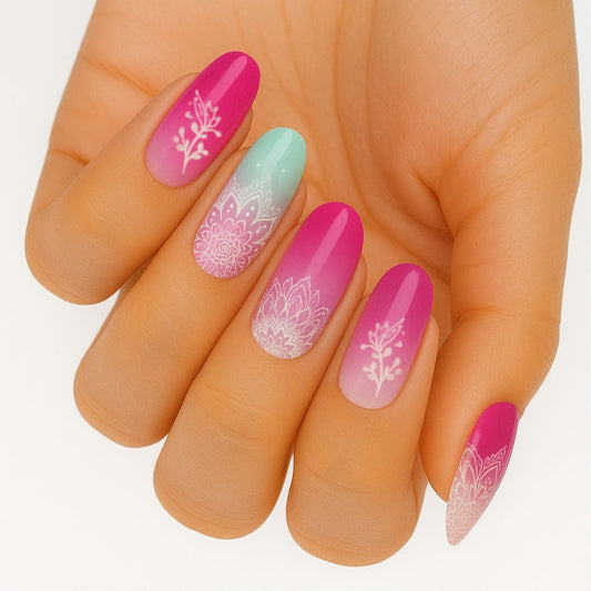 Pink ombre nail wraps with white mandala lace patterns on hand