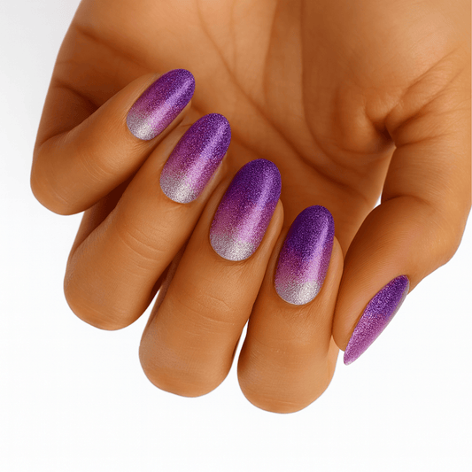 Purple glitter ombre nail wraps on hand fading from violet to silver