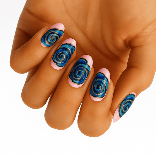 Hand wearing blue metallic swirl nail wraps with gold accents on natural nails