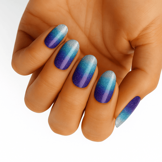 Blue to purple ombre gradient nail wraps with shimmer finish on hand