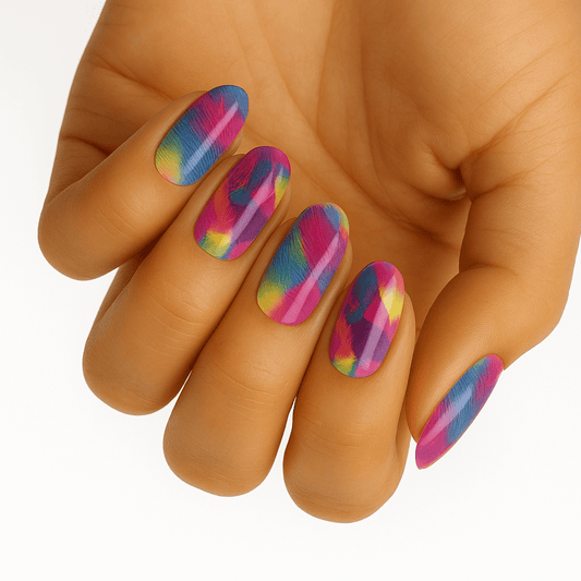 Hand wearing vibrant rainbow brushstroke nail wraps with multicoloured abstract paint effect design