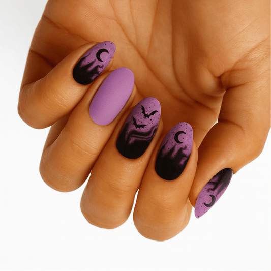 Witching Hour Halloween nail wraps on hand featuring purple ombre with black bats and moons