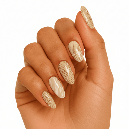 Nude gel nail wraps with feather pattern design on hand for elegant nail art