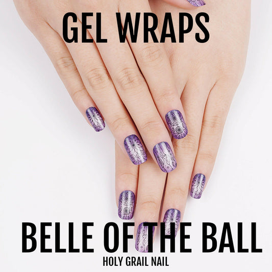 Purple glitter gel nail wraps with winter snowflake pattern on manicured hand