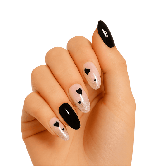 Hand wearing black heart gel nail wraps with pink glitter accent nails for Valentine's Day