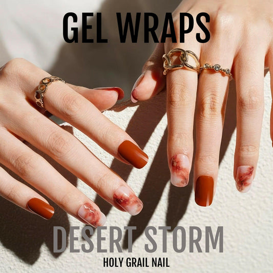 Orange and red marble gel nail wraps on hands with gold rings