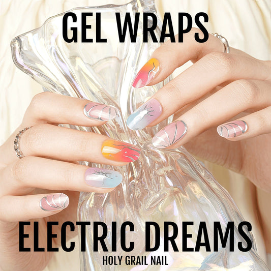 Hand holding crystal wearing electric multicolour marble gel nail wraps with rainbow swirls