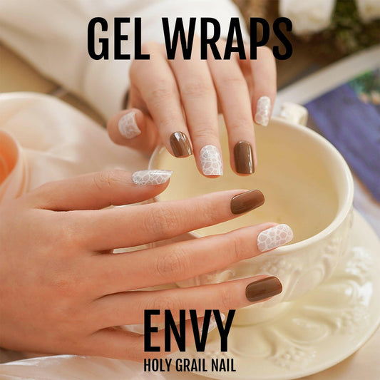 Brown and ivory gel nail wraps on hands creating sophisticated neutral manicure