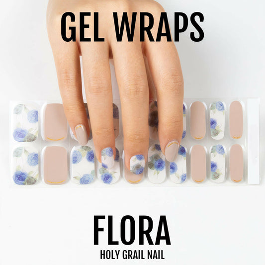 Blue watercolour floral gel nail wraps on hand showing translucent botanical design