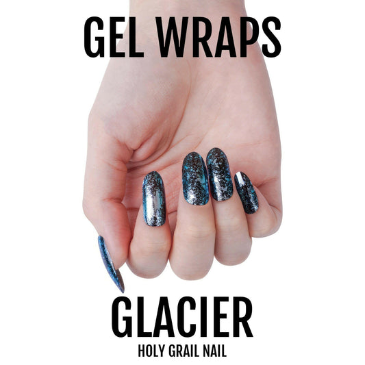 Blue glittery gel nail wraps on hand showing holographic chrome finish