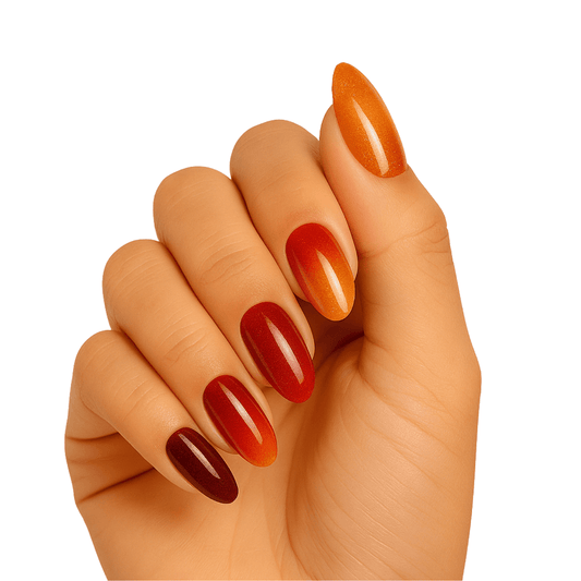 Hand wearing glossy amber gradient gel nails in warm orange to burgundy ombre finish
