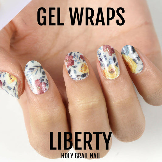 Floral gel nail wraps on hand showing vintage botanical pattern with multicoloured flowers