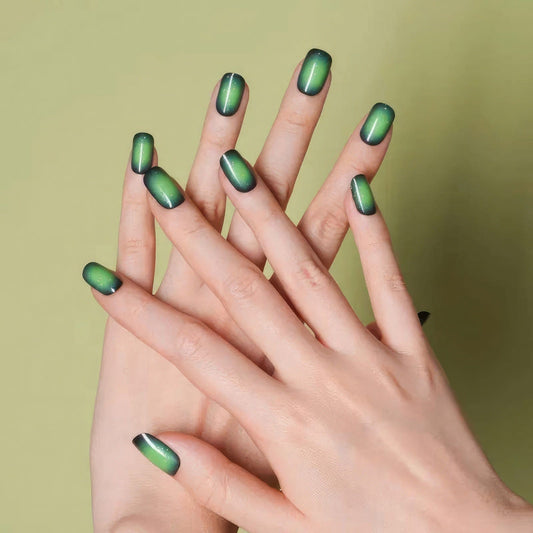Green chrome gel nail wraps on hands showing iridescent metallic finish manicure