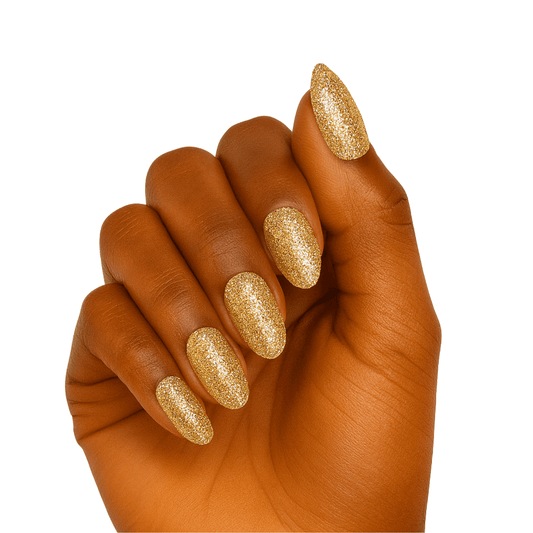 Hand wearing gold glitter gel nail wraps with champagne metallic finish for elegant manicure look