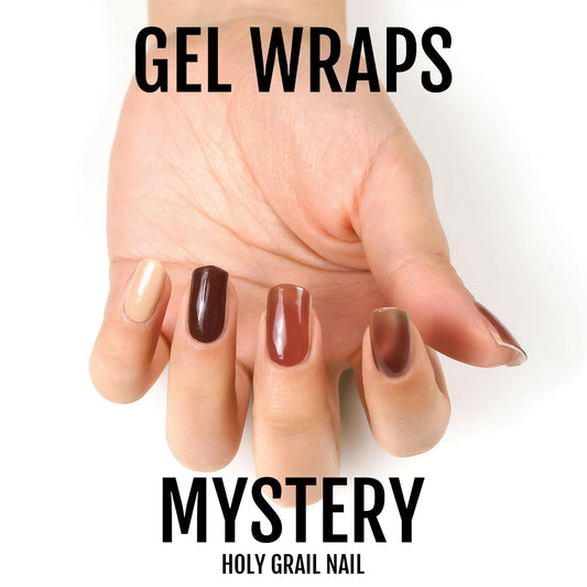 Hand wearing brown and neutral gel nail wraps in autumn tortoiseshell shades