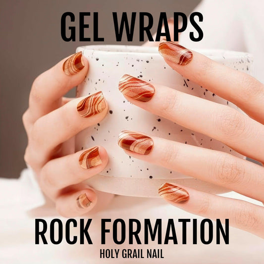 Rock formation gel nail wraps on hand showing rust marble stone pattern