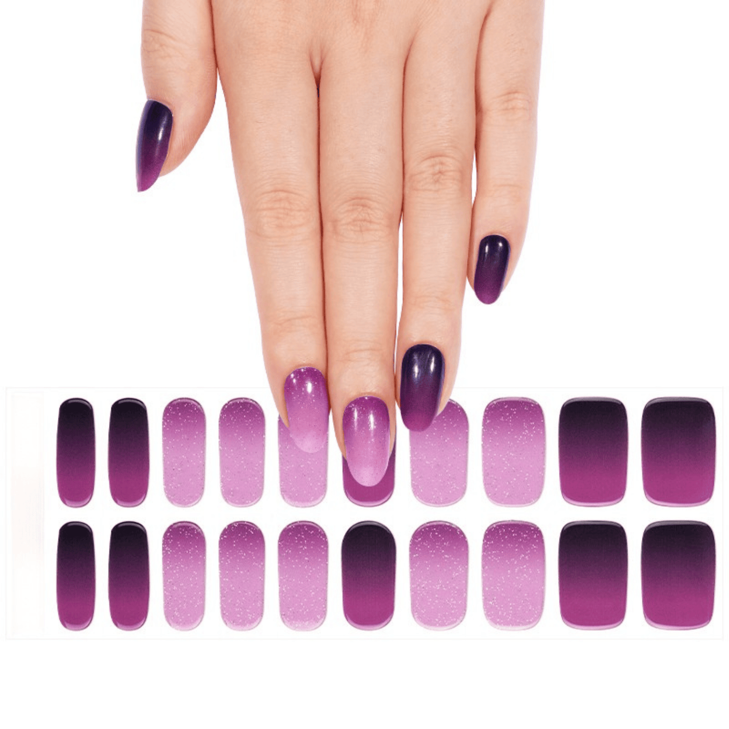 Hand with purple gel nails next to ombre nail wrap sheet in plum gradient shades
