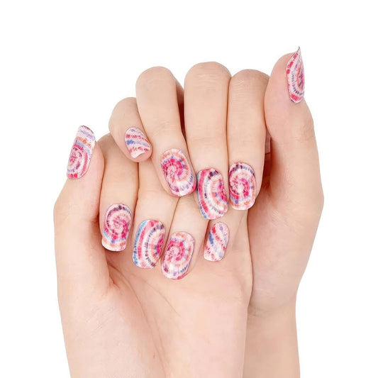 Pink and purple tie dye gel nail wraps on hands showing swirl pattern