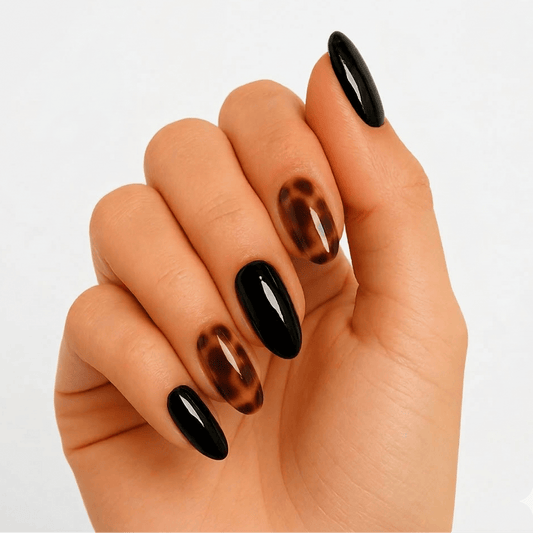 Black and brown tortoiseshell gel nails with glossy finish on hand