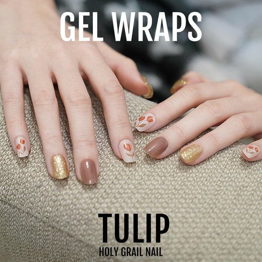 Brown and gold floral gel nail wraps with tulip design on hand showing autumn manicure
