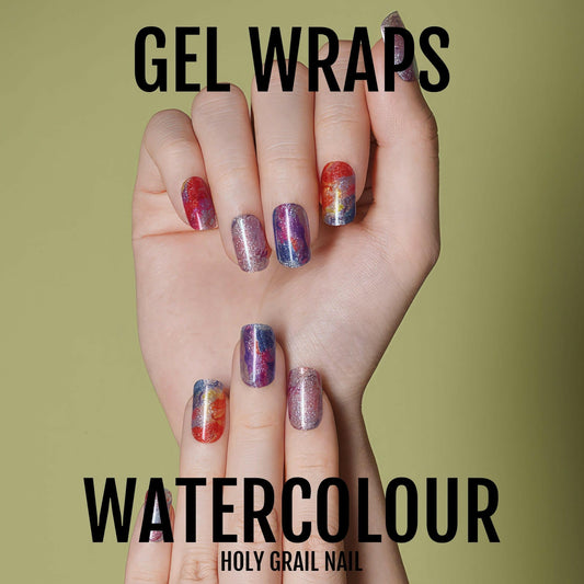 Watercolour gel nail wraps on hands showing multicoloured abstract artistic design