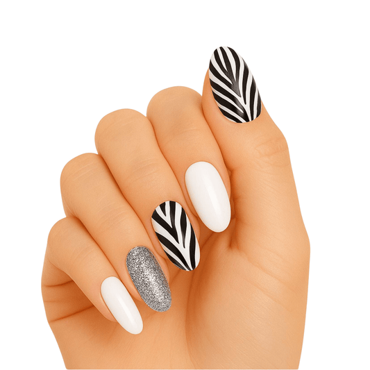 Hand wearing zebra stripe gel nail wraps with white and silver glitter accent nails