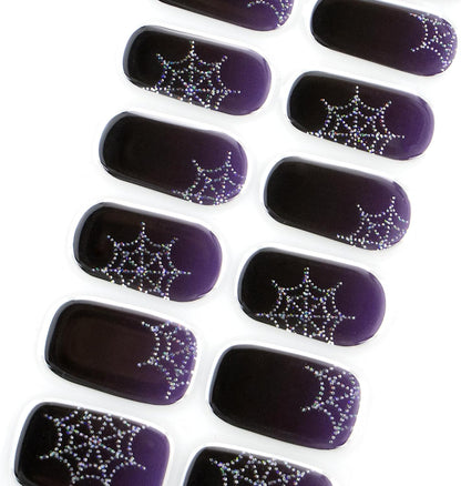 Deep purple glossy semi-cured gel nail wraps with glittery silver spiderweb corner accents.