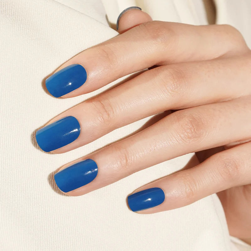Glossy cobalt blue semi-cured gel nail wraps in a square short-to-medium length