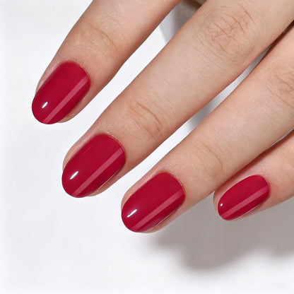 Short oval soft gel press-on nails in glossy deep cherry red