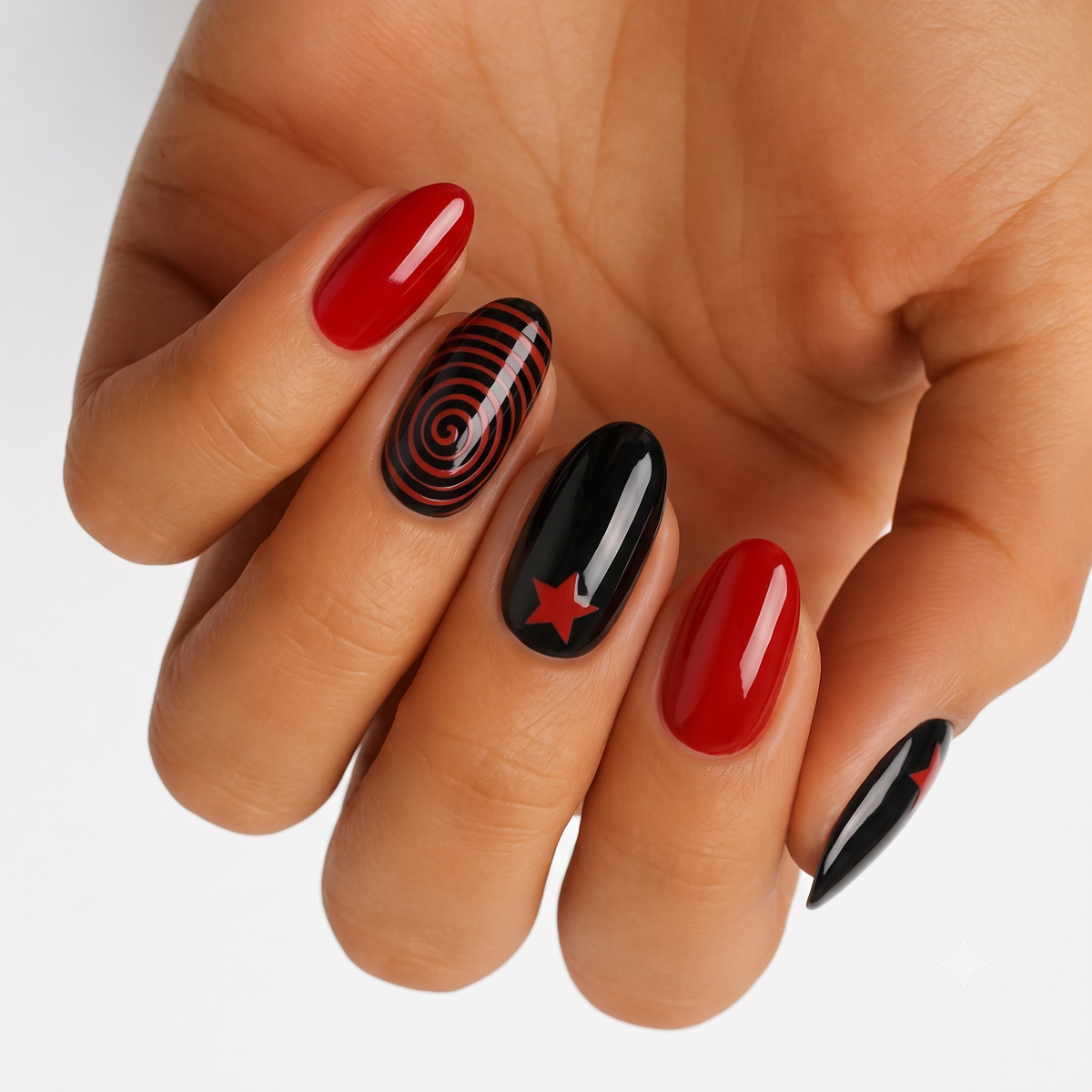 Glossy red and black press-on nails with spiral swirl and star accent designs