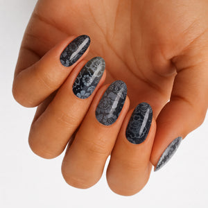 Black semi-cured gel nail wraps with grey lace-inspired floral pattern, glossy oval press-on nails