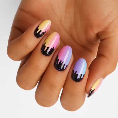 Press-on nails with pastel rainbow ombré tips and black dripping paint, star accents