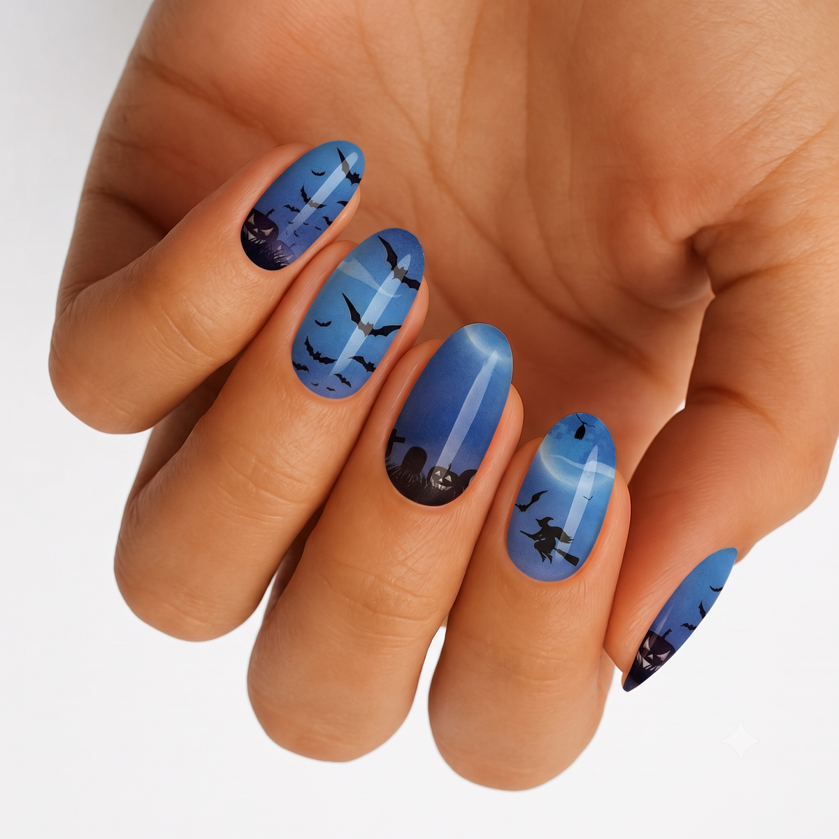 Blue moonlit semi-cured gel nail wraps with bats, witch, and pumpkin Halloween silhouettes