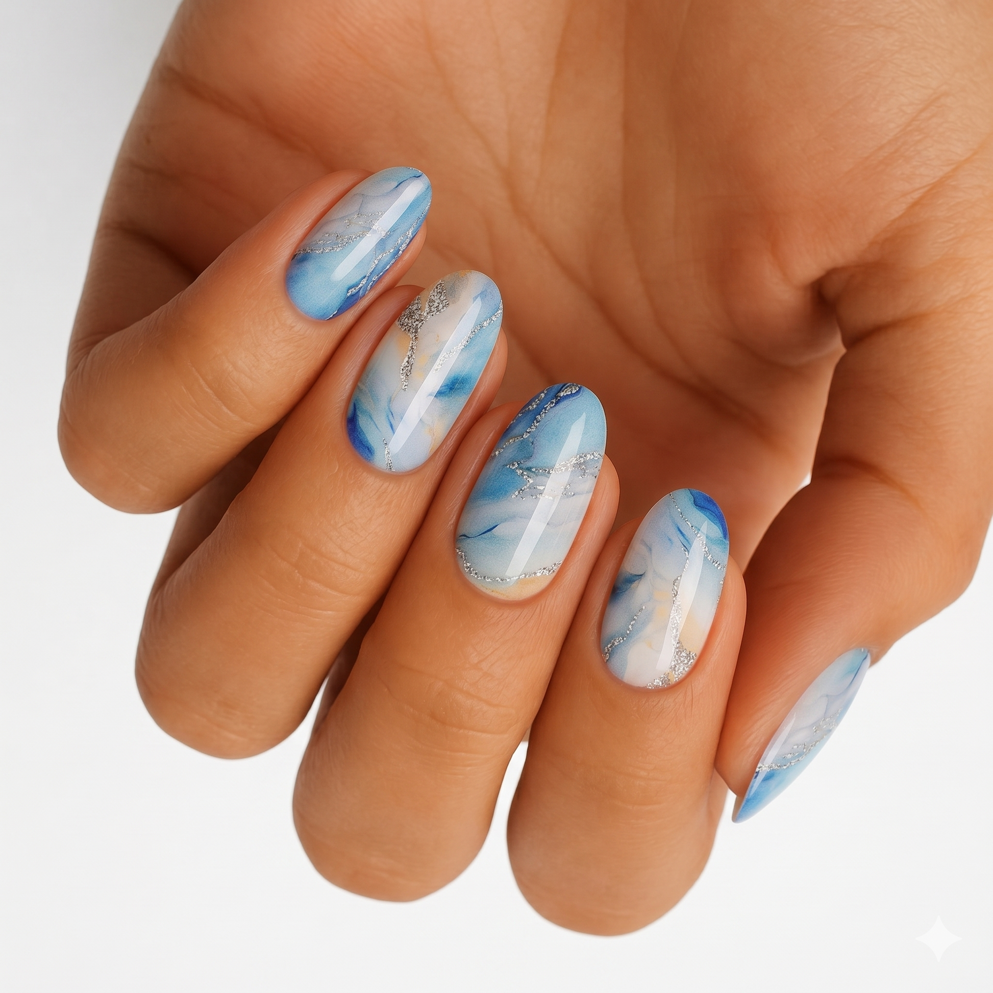 Blue marble nail wraps on hand showing stone-effect granite pattern nail art design